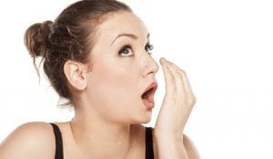 Woman smells her own breath